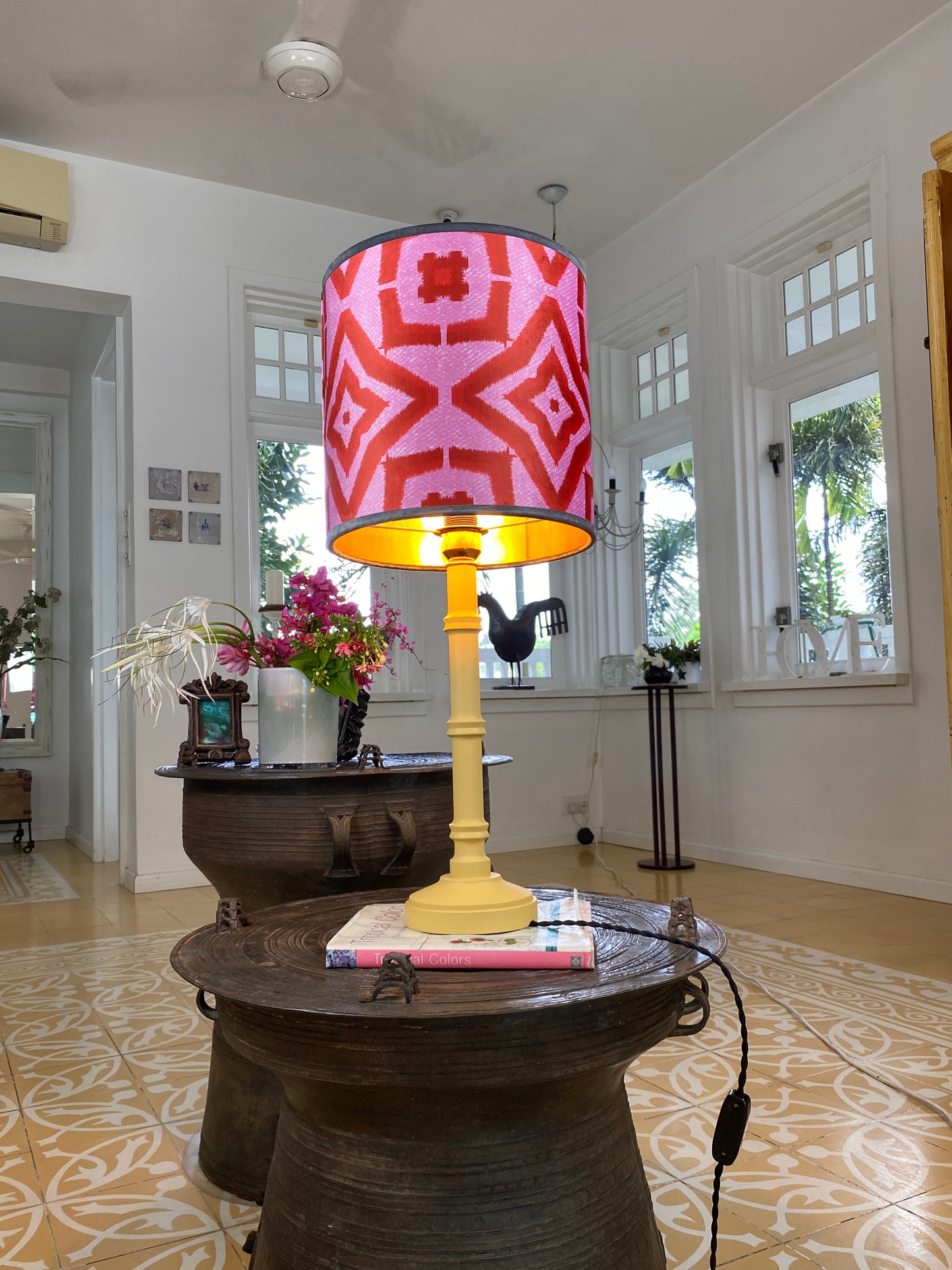 Red ikat velvet lampshade with yellow wooden lamp base