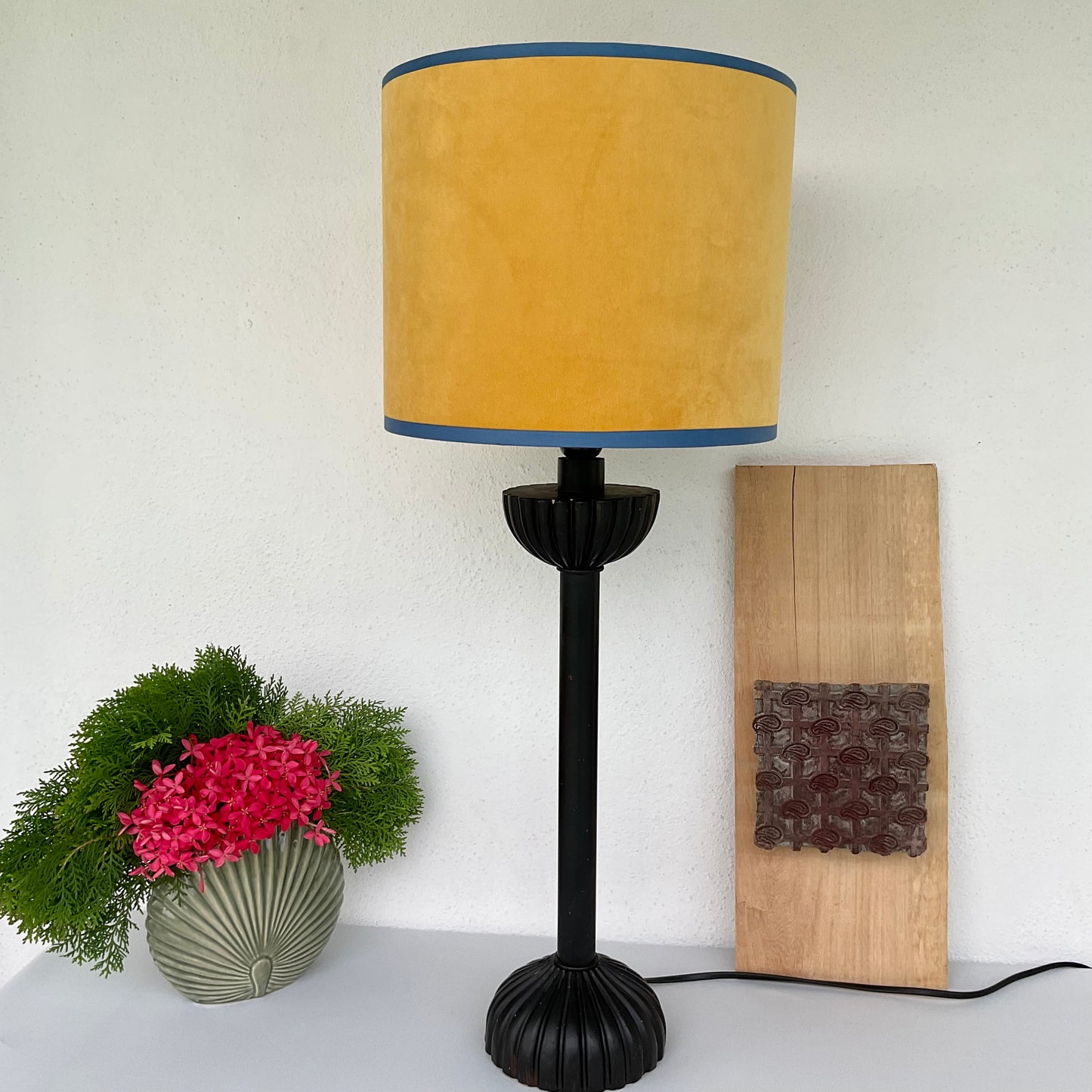 Yellow velvet lampshade with black wooden lamp base