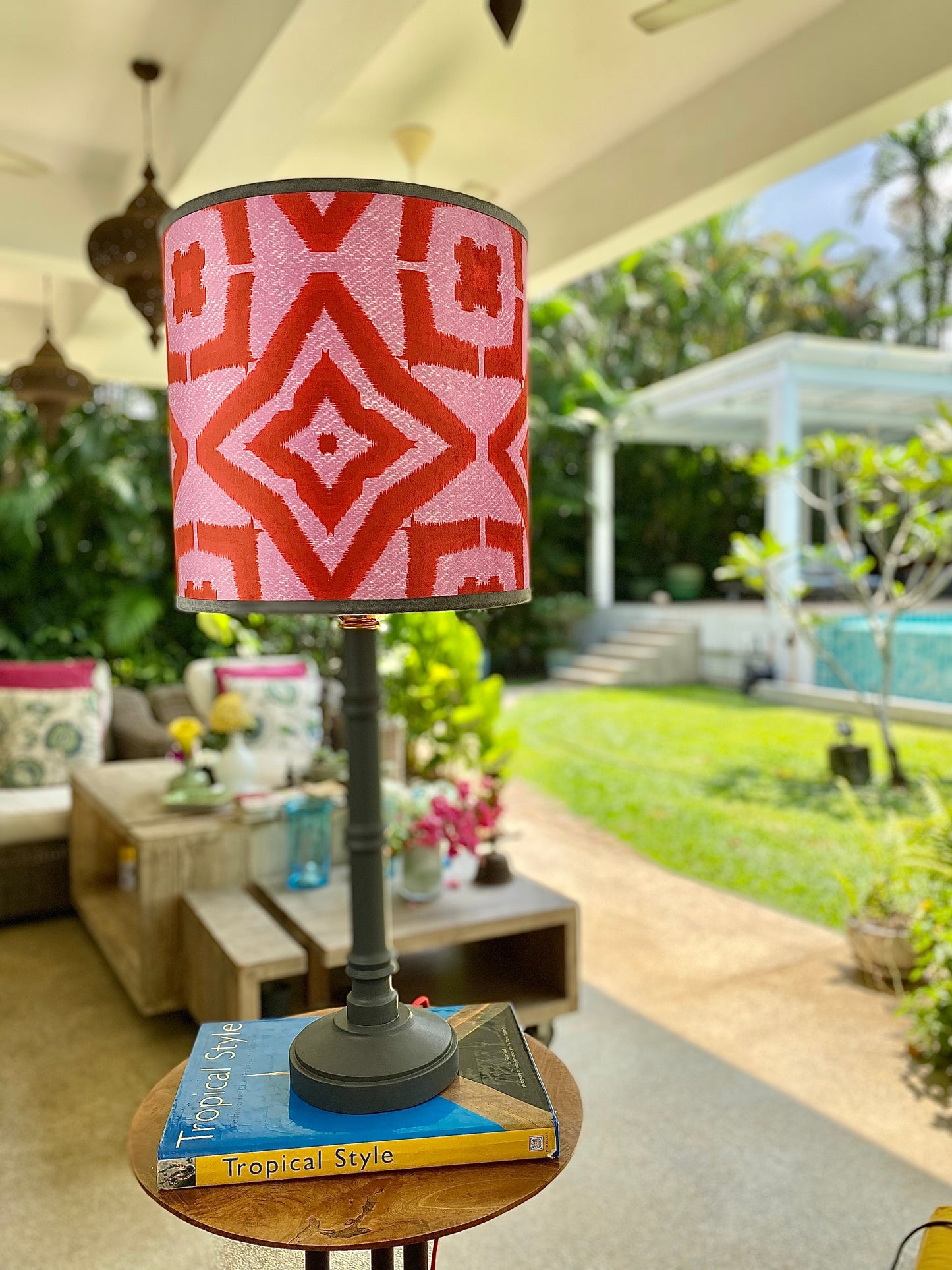 Red ikat pattern lampshade with grey wooden lamp base