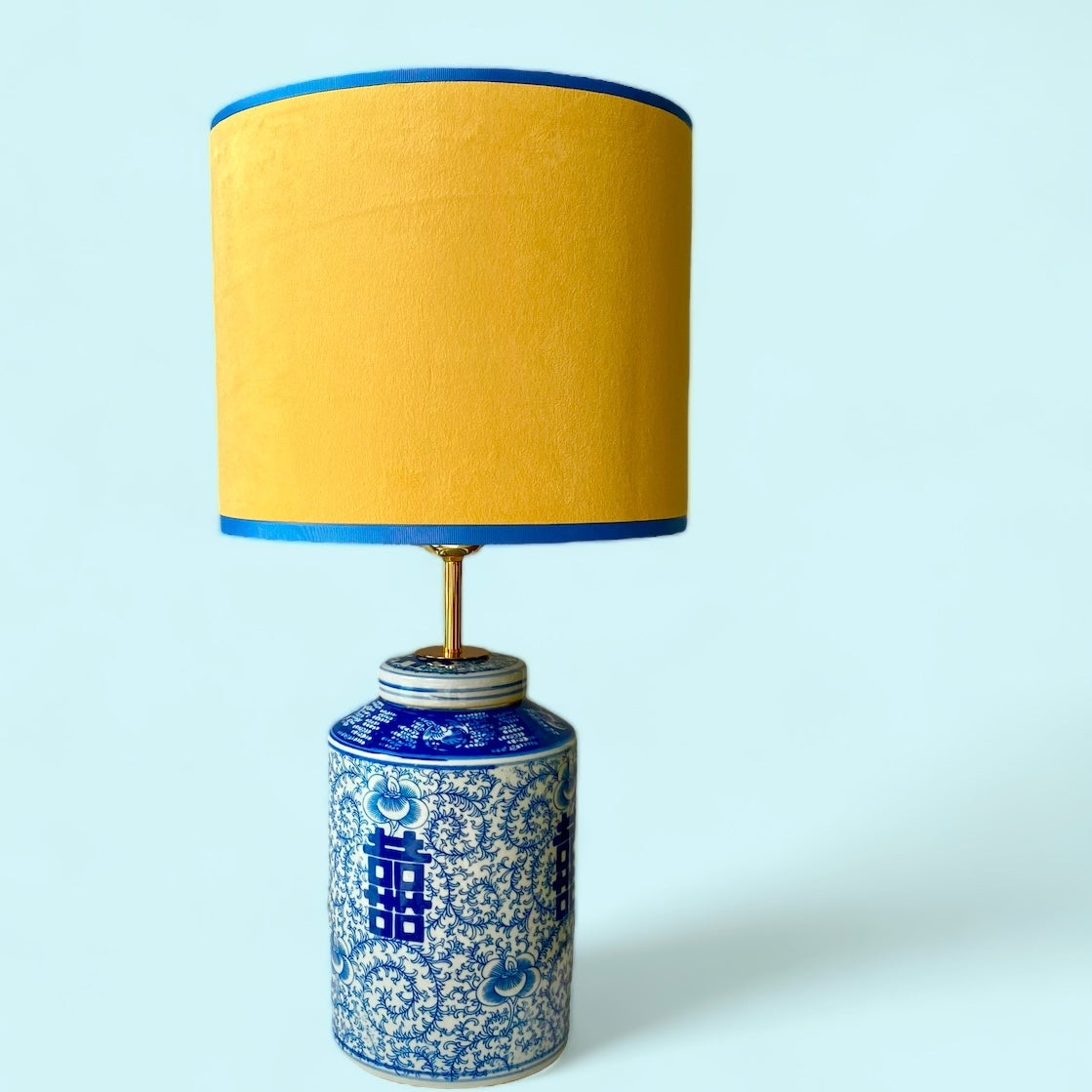 Yellow lampshade with blue and white lamp base