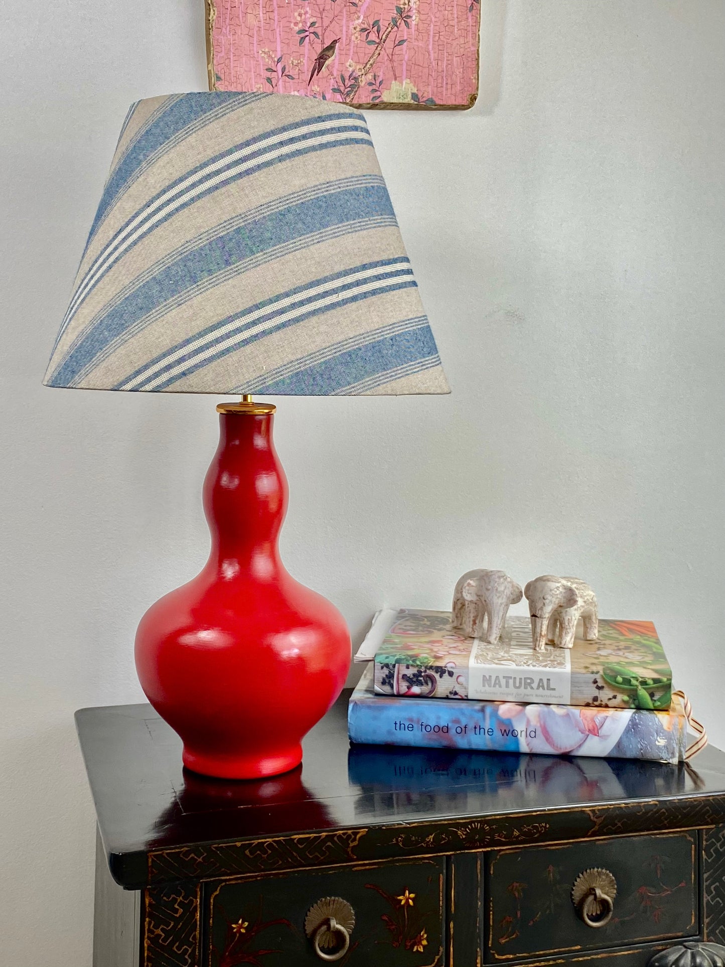 Blue and beige lampshade with red giurd shape lamp base