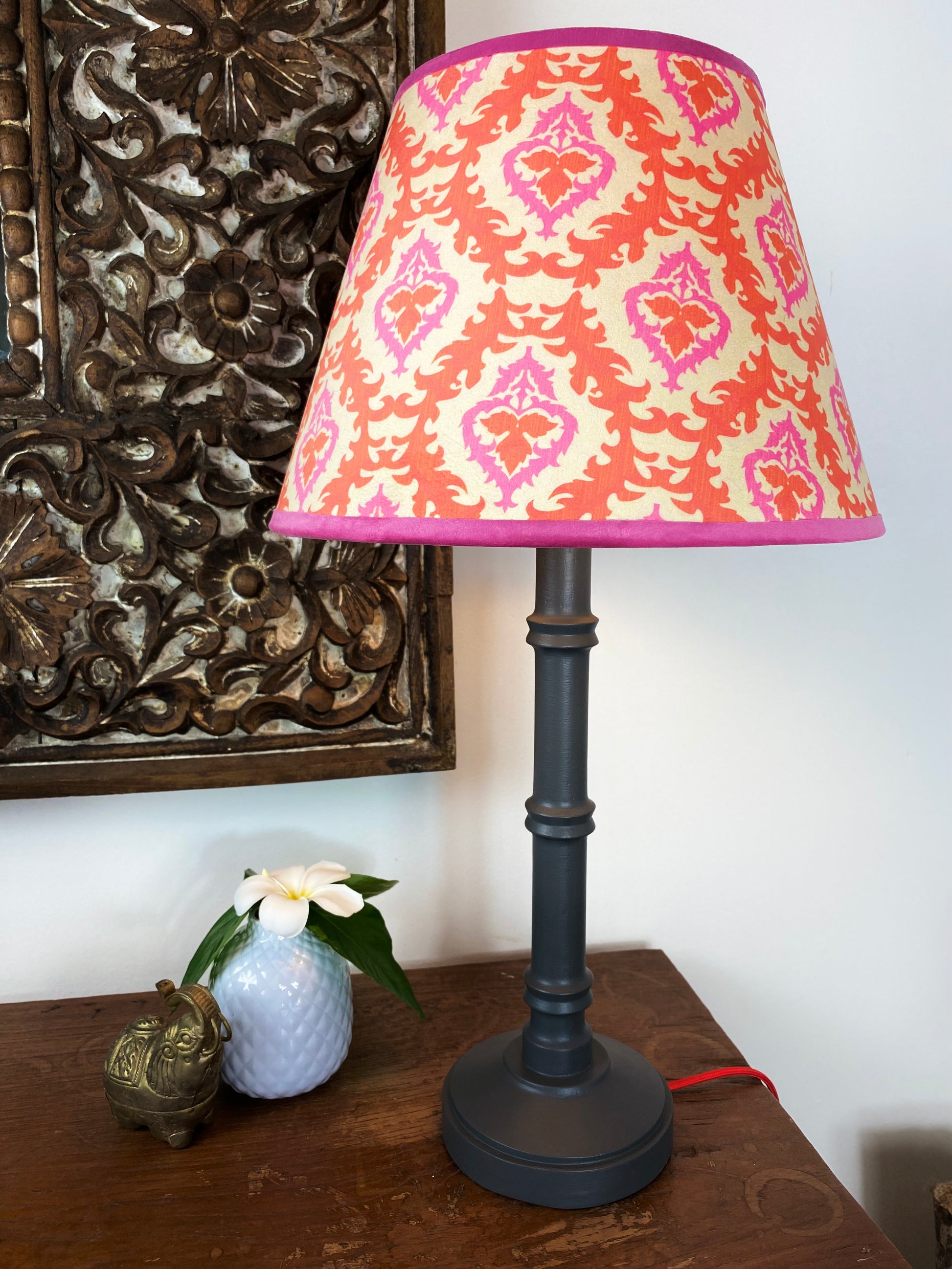 Cone shape pink and orange lampshade with grey wooden lamp base