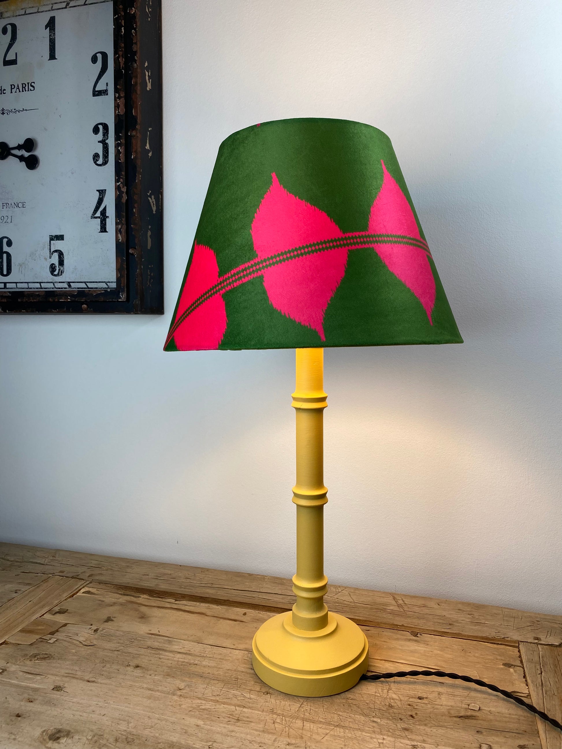 Pink and green lampshade with yellow wooden lamp base