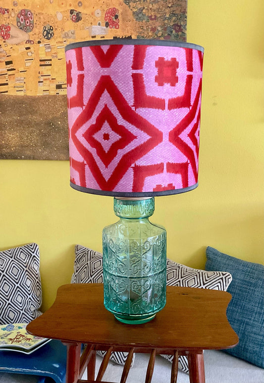 Red ikat pattern lampshade with textured glass lamp base